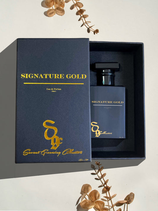 Premium SIGNATURE GOLD Cologne by Savant Grooming Collective. Sleek Compact Size bottle showing itself from inside cologne box aerial view